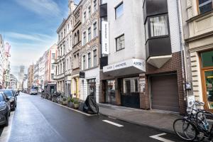 a city street with buildings and bikes parked on the street at Astor & Aparthotel in Cologne