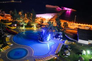 an overhead view of a swimming pool at night at Hotel El Habib Monastir in Monastir