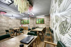 a restaurant with wooden tables and green chairs at Kilic Boutique Hotel in Istanbul