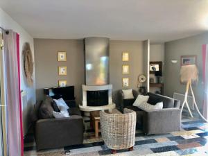 a living room with two couches and a fireplace at Villa Pierretti - Vue mer Panoramique in Coti-Chiavari
