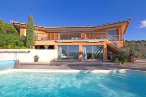 a house with a swimming pool in front of a house at Villa Pierretti - Vue mer Panoramique in Coti-Chiavari