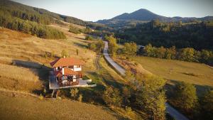 a small house on a hill with a road at Mountain View Retreat Mionica in Kosjeric