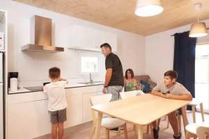 a group of people in a kitchen with a table at ZEcamping 3 familial piscine club enfant animaux acceptés animations in Malgrat de Mar