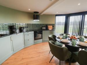 a kitchen with a table and chairs in a room at The Corn Silo in Ipswich