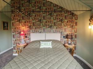a bedroom with a bed and a wall with plates at The Corn Silo in Ipswich