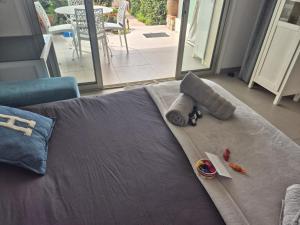 a bed with towels and toys on top of it at Juan Plage in Juan-les-Pins