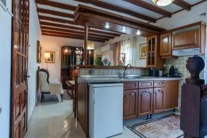 a kitchen with wooden cabinets and a sink at Zoe House in Sidari