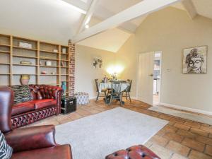 a living room with a couch and a table at Ivy Barn in Norwich