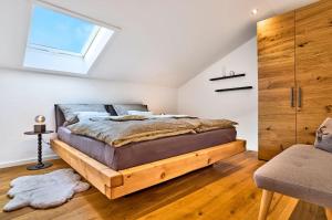 a bedroom with a wooden bed and a window at Ferienwohnung Fritz in Bodenmais