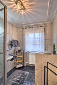 a bathroom with a sink and a ceiling fan at Ferienwohnung Fritz in Bodenmais