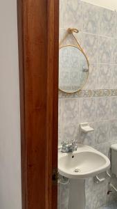 a bathroom with a white sink and a mirror at Ecopolis hospedajes casa de campo tradicional in Papagalleros +93 photos