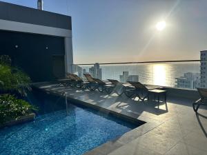 a swimming pool on the roof of a building at Rodadero Ocean View Luxury Apt with Rooftop Pool in Taganga