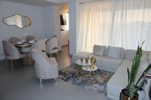 a living room with a white couch and a table at Rodadero Ocean View Luxury Apt with Rooftop Pool in Taganga
