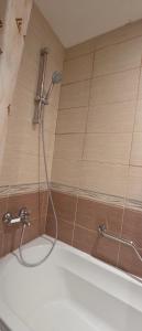 a shower with a hose in a bathroom at НАРцис in Bŭnzareto