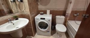 a bathroom with a toilet sink and a washing machine at НАРцис in Bŭnzareto