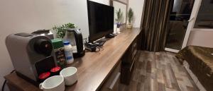 a desk with a monitor and a computer on it at НАРцис in Bŭnzareto