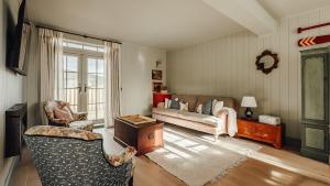 a living room with a couch and a chair at Dumbarnie West Cottage in Kirkton of Largo