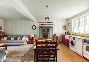 a kitchen and living room with a table and a couch at Dumbarnie West Cottage in Kirkton of Largo