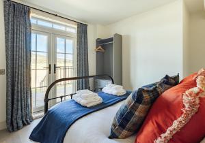 a bedroom with a bed with towels on it at Dumbarnie West Cottage in Kirkton of Largo