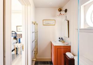 a bathroom with a sink and a mirror at Dumbarnie West Cottage in Kirkton of Largo +46 photos