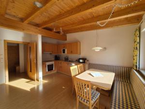 a kitchen with a table and a dining room at Haus Gande in Spiss