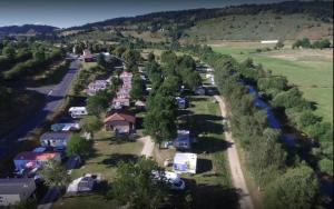 an aerial view of a village with trees and a river at ZEcamping 3 étoiles dog friendly piscine chauffée en bordure de l'Allier in Lespéron +59 photos
