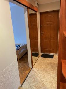 a mirror in a room with a door at Apartament 94 Konin in Konin +3 photos