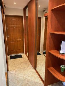 a walk in closet with wooden shelves and a door at Apartament 94 Konin in Konin