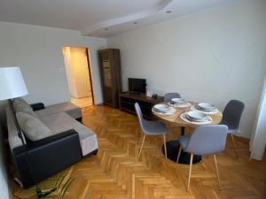 a living room with a table and a couch at Apartament 94 Konin in Konin