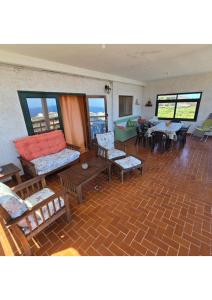 a living room with couches and tables and windows at FINCA LA JORADITA in Tamaduste