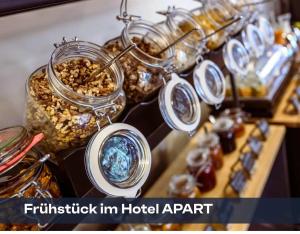 a display of glass jars of food on a table at Hotel Bauernhof - Self Check-In Hotel in Rotkreuz +12 photos