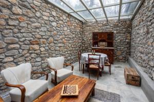 a room with a stone wall with a glass ceiling at Pavliani Aesthesis by Raise in Pavliani +80 photos
