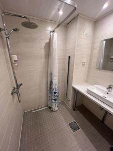 a bathroom with a shower and a sink at Dorell in Tallinn