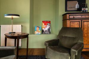 a living room with a chair and a table at La Trifola in Scurzolengo +21 photos