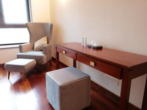 a office with a desk and a chair and a chair at Cinnamon Life Residency in Colombo +30 photos