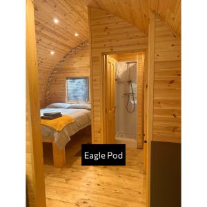 a bedroom with a bed and a shower in a room at Forrester Park Glamping Pods - Eagle Pod and Birdie Pods in Great Totham +28 photos