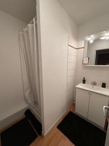 a bathroom with a sink and a toilet and a mirror at "1-2-3 SOLEIL" Duplex - 8 pers - La Mongie Pic d'espade in La Mongie