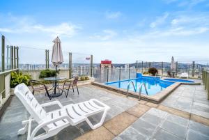 a patio with a table and chairs and a swimming pool at Espacio Viña- 1D with Wifi in Viña del Mar