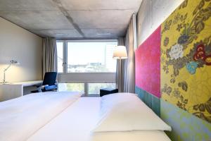 a hotel room with a bed and a window at HOTEL APART - Welcoming l Urban Feel l Design in Rotkreuz
