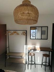 a dining room with a table and two stools at L'escale du minotaure in Toulouse +7 photos