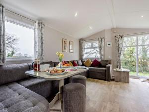 a living room with a couch and a table at 3 Bed in Ventnor oc-94278 in Rookley