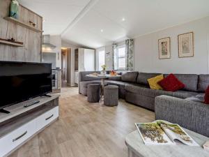 a living room with a couch and a flat screen tv at 3 Bed in Ventnor oc-94278 in Rookley
