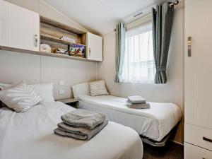 a room with two beds with towels on them at 3 Bed in Ventnor oc-94278 in Rookley