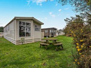 a picnic table in front of a tiny house at 3 Bed in Ventnor oc-94278 in Rookley