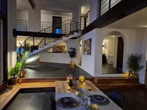 a living room with a table and a staircase at OCV Forest in Durbuy