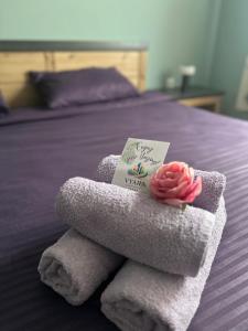 a towel with a flower on top of a bed at Vyara apartments 56 in Varna City