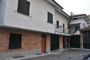 ceglany budynek z czarnymi oknami i balkonem w obiekcie Residenza San Rocco w Asti