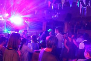 a group of people dancing in a room with lasers at ZEcamping 3 étoiles pet friendly animations piscine chauffée in Merdrignac +56 photos