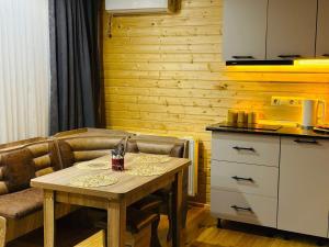 a small kitchen with a table and a counter and a table and a chair at Kobuleti Seaside Cottage in Kobuleti