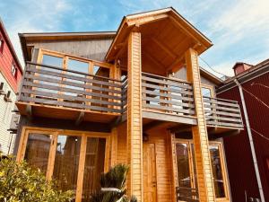 a house with a deck on top of it at Kobuleti Seaside Cottage in Kobuleti